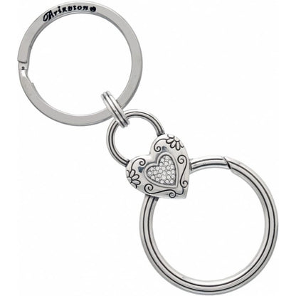 Brighton key fob with silver-tone heart charm, crystal center, scroll detailing, and dual split rings on a white background