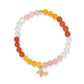 Brighton beaded bracelet with pink, orange, yellow, and opalescent beads and gold-plated crystal butterfly charm on a white background