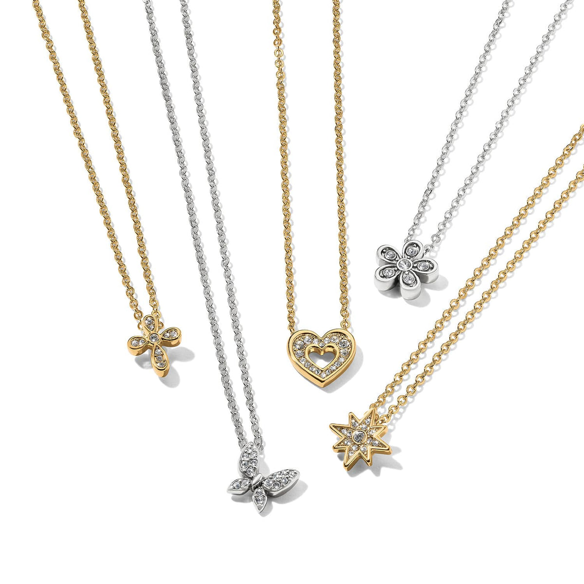 Brighton pendant necklaces with gold and silver chains featuring cross, butterfly, heart, flower, and star crystal pendants on a white background