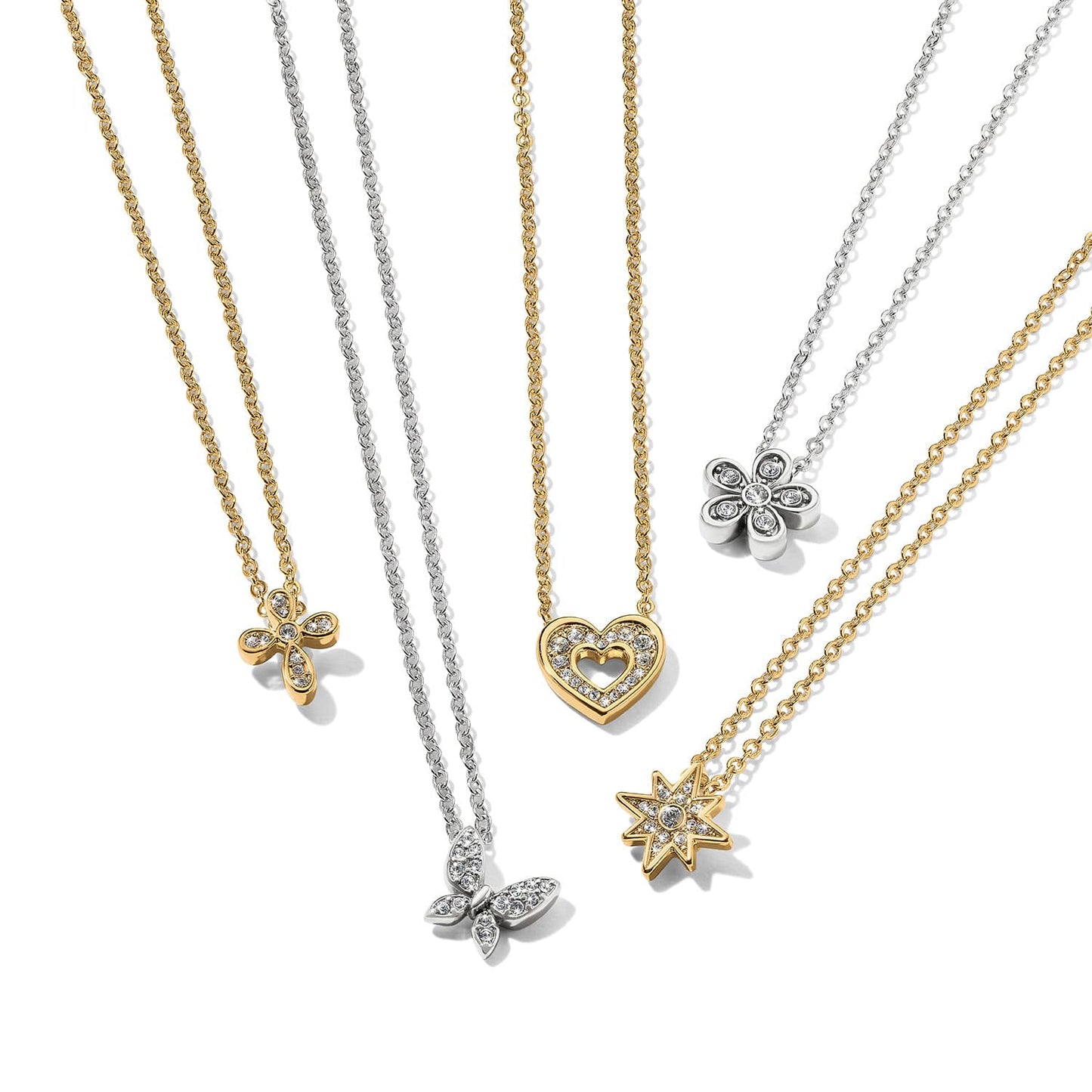 Brighton pendant necklaces with gold and silver chains featuring cross, butterfly, heart, flower, and star crystal pendants on a white background