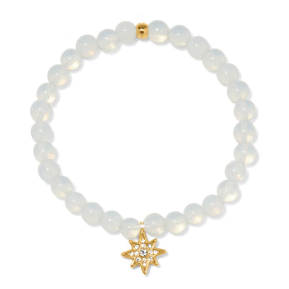 Brighton beaded stretch bracelet with opalescent beads and gold-plated star charm with crystal accents on a white background