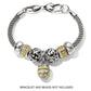 Brighton charms with silver-plated scrollwork beads, yellow crystal spacers, and yellow enamel floral egg drop on white background