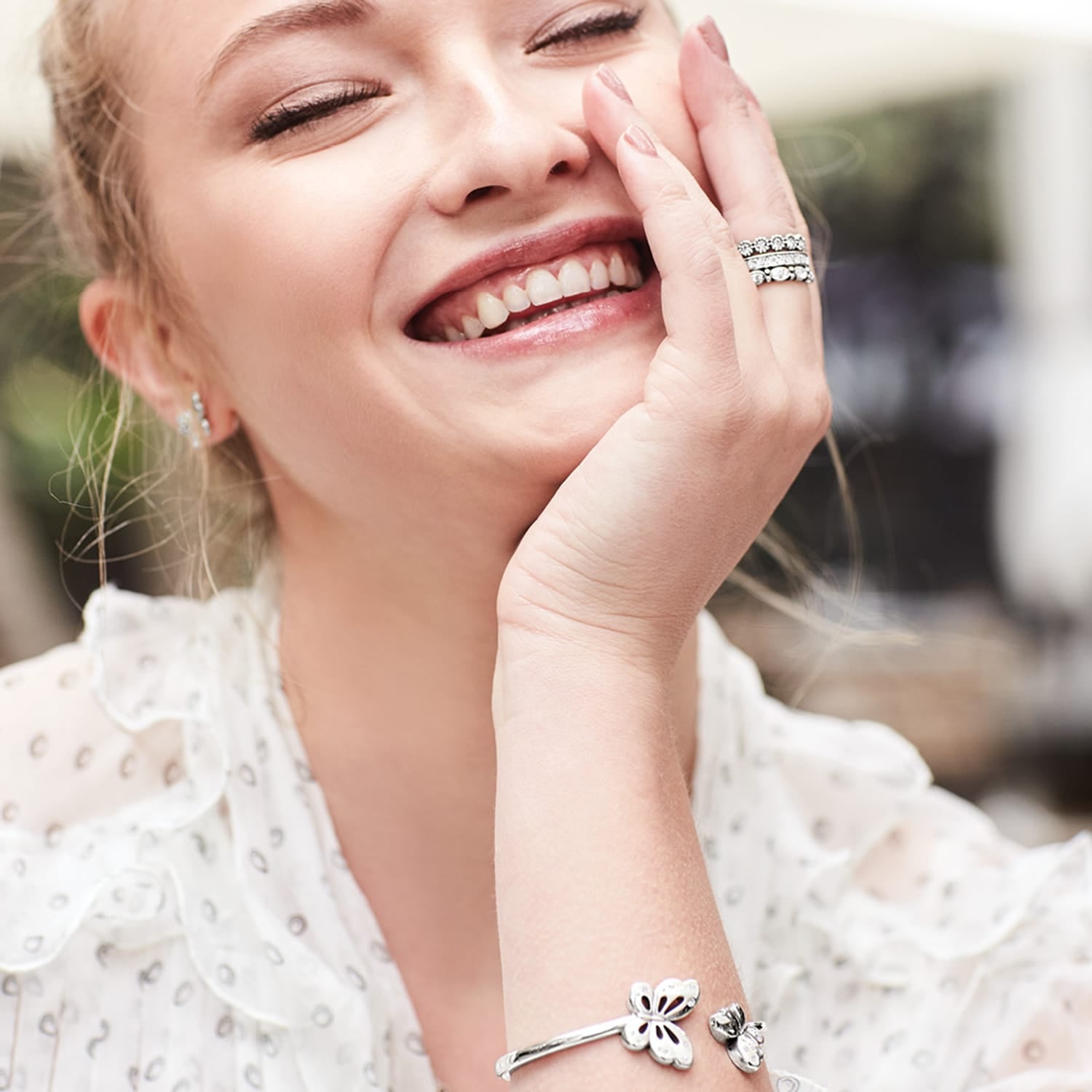 Model wearing Brighton silver-plated stacked rings with crystal accents and coordinating Brighton accessories including earrings and bracelet