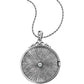 Brighton pendant necklace with silver-plated round locket, radiating sunburst texture, central crystal, and scrollwork bail on a white background