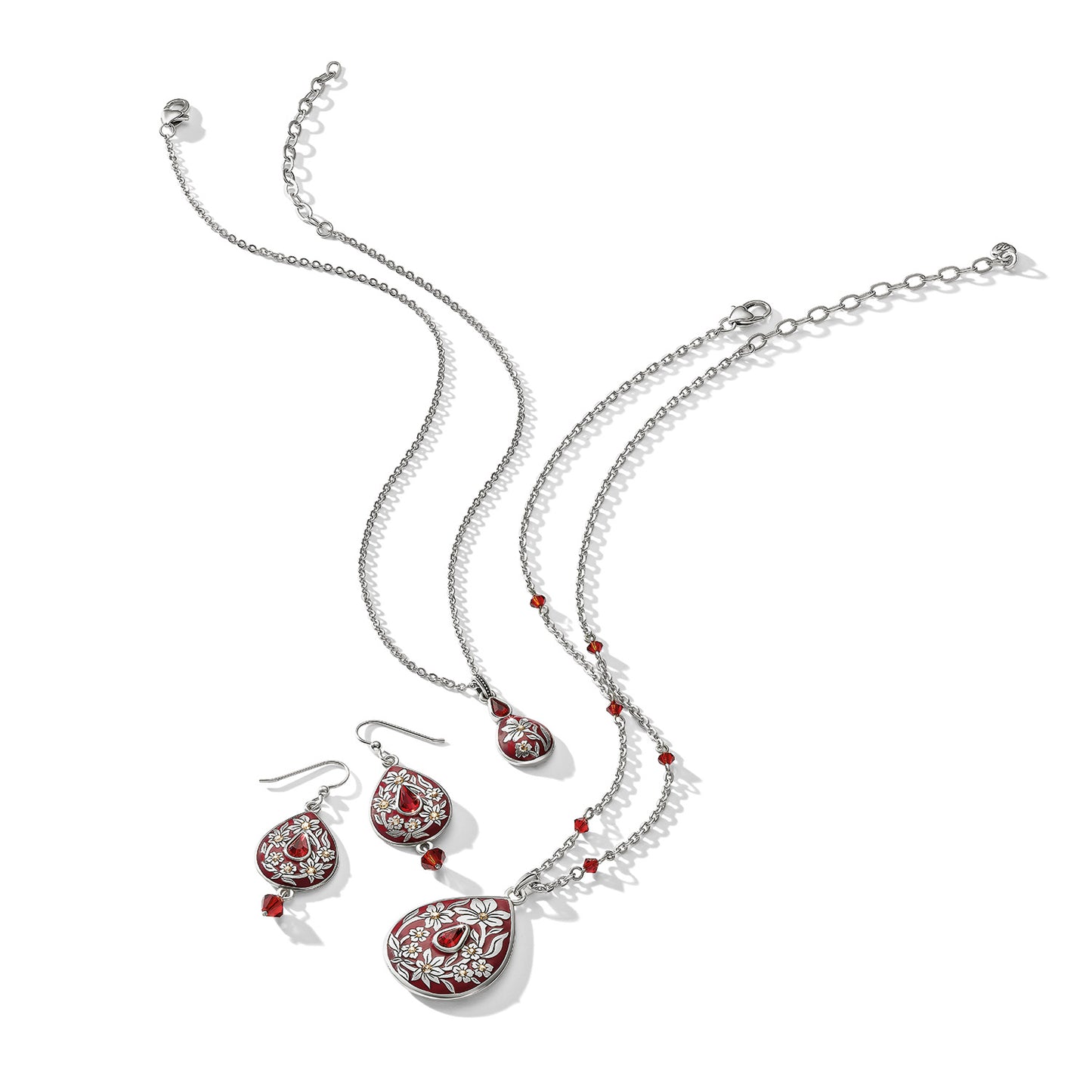 Brighton silver-plated necklace and drop earrings set with red enamel teardrops, floral detailing, and crystal beads on a white background