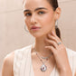 Model wearing a Brighton silver-plated teardrop pendant necklace with enamel floral design and coordinating Brighton accessories