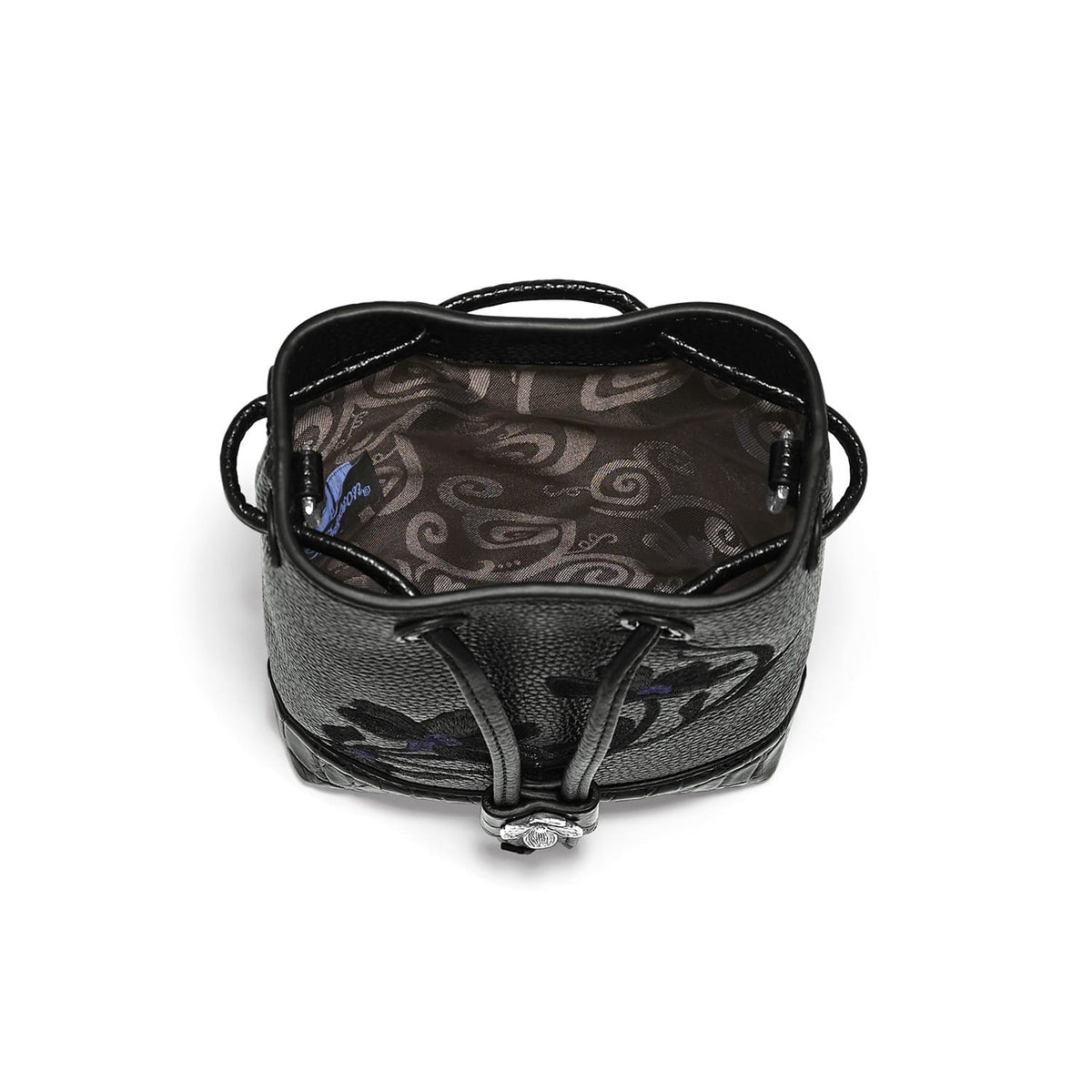 Close-up of Brighton black handbag interior view showing patterned fabric lining and drawstring closure with silver-tone charm