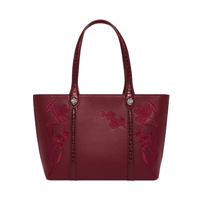 Brighton burgundy leather tote handbag with pink floral embroidery and croc-embossed straps on a white background