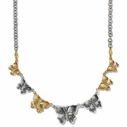 Brighton necklace with alternating silver-tone and gold-tone butterfly links, crystal accents, and mixed chain on a white background