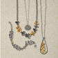 Brighton two-tone floral jewelry set styled with necklaces and bracelets featuring silver and gold flower motifs