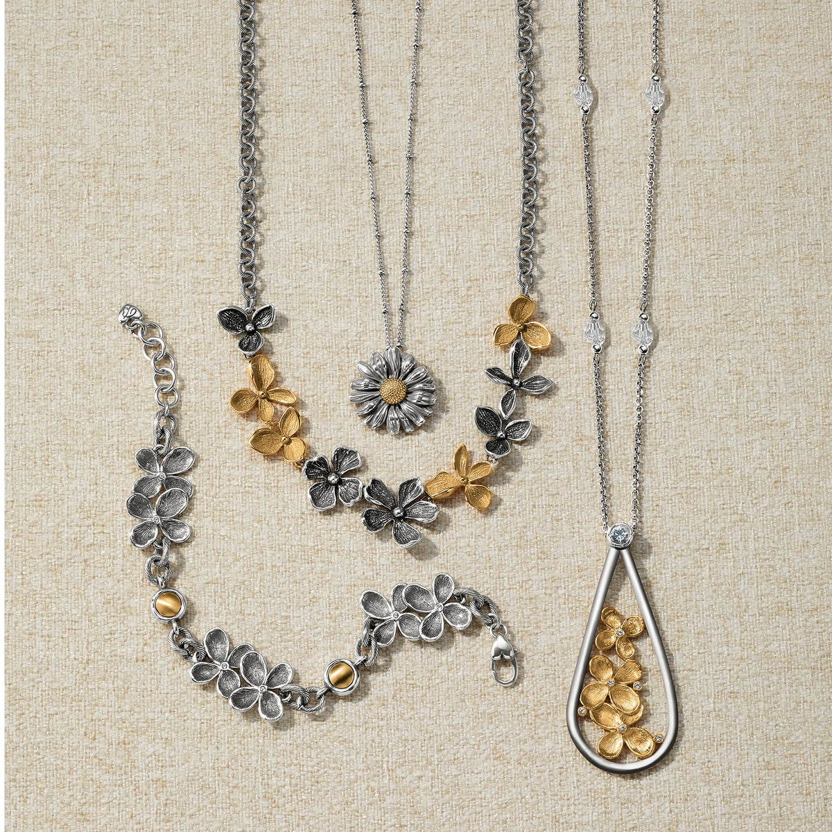 Brighton two-tone floral jewelry set styled with necklaces and bracelets featuring silver and gold flower motifs