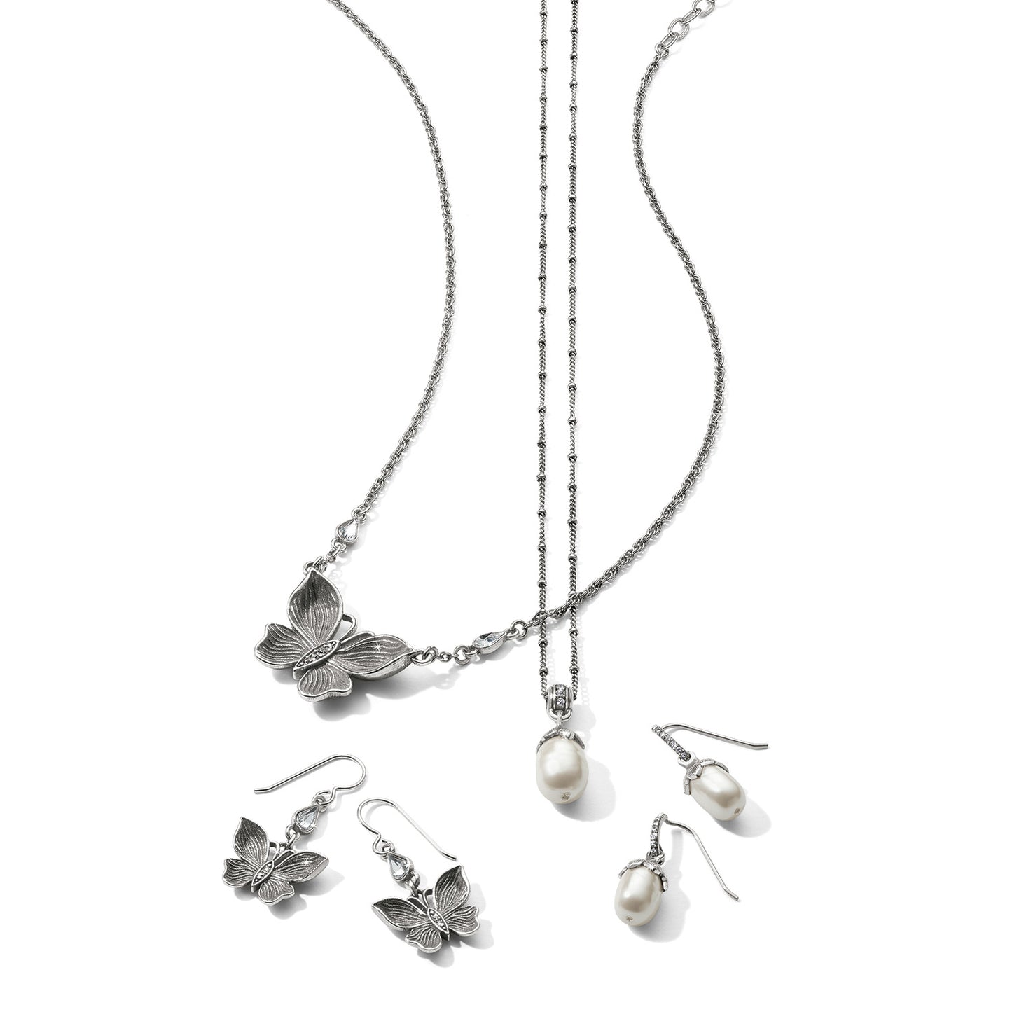 Brighton silver-plated butterfly necklace and earrings with rice pearl drop necklace and matching pearl earrings on a white background