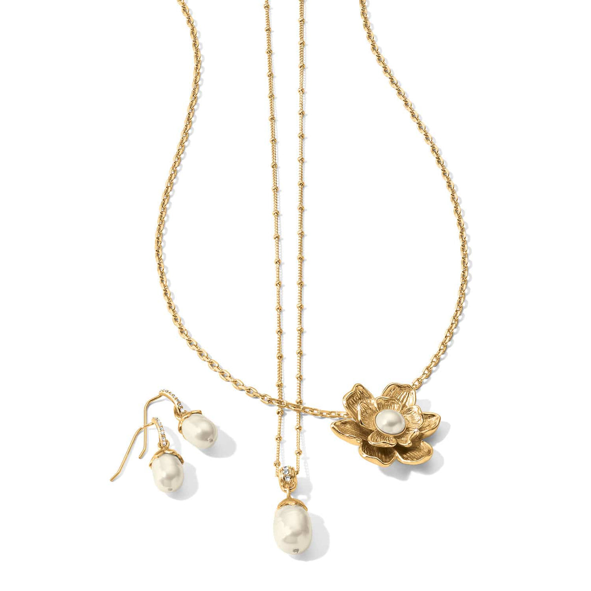 Brighton gold-tone necklaces and pearl drop earrings with crystal accents and flower pendant on a white background