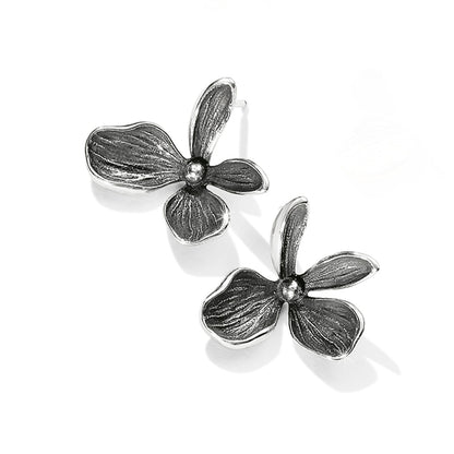 Brighton floral stud earrings with three-petal design and oxidized silver-tone finish on a white background