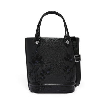 Brighton black leather tote handbag with floral embroidery, croc-embossed trim, and adjustable crossbody strap on a white background