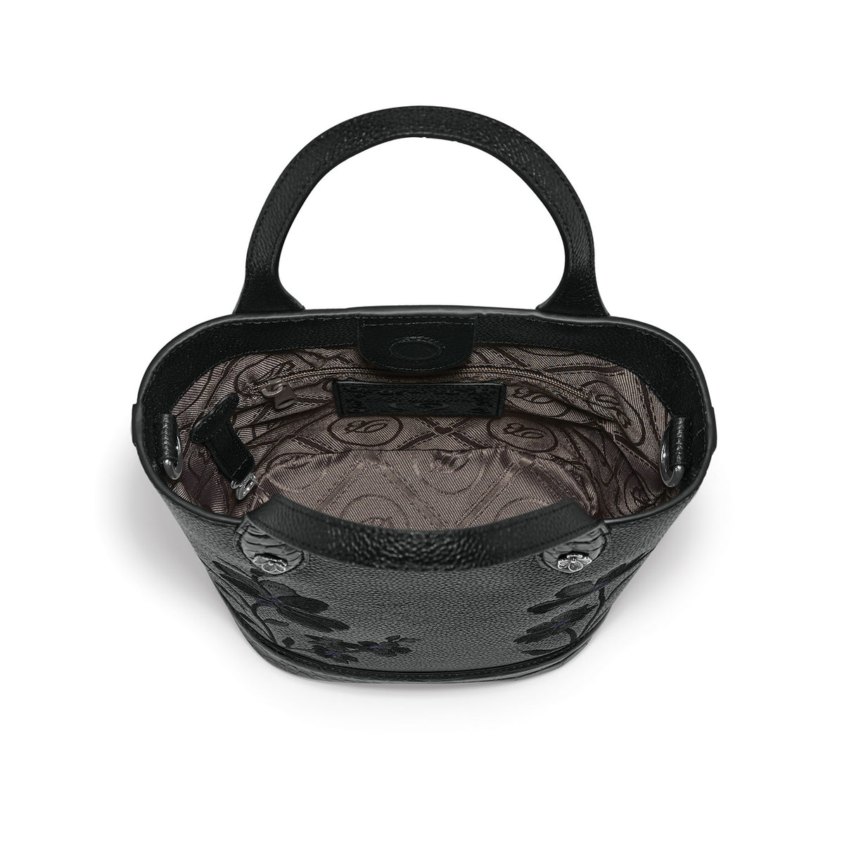 Brighton black handbag interior view showing patterned fabric lining, zippered pocket, and rolled top handles on a white background