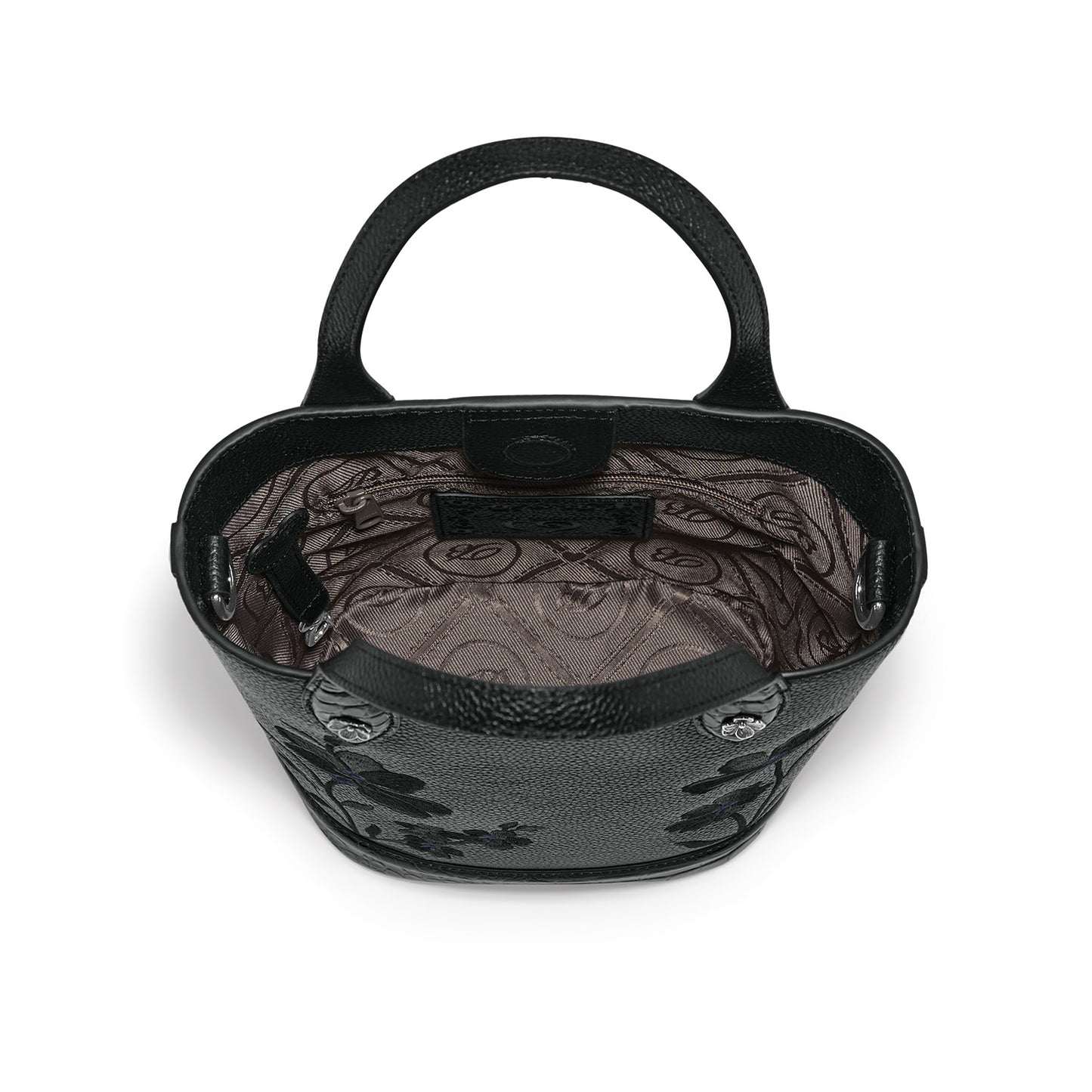 Brighton black handbag interior view showing patterned fabric lining, zippered pocket, and rolled top handles on a white background