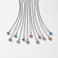 Brighton silver-plated flower pendant necklaces with assorted colored crystals arranged in a row on a white background