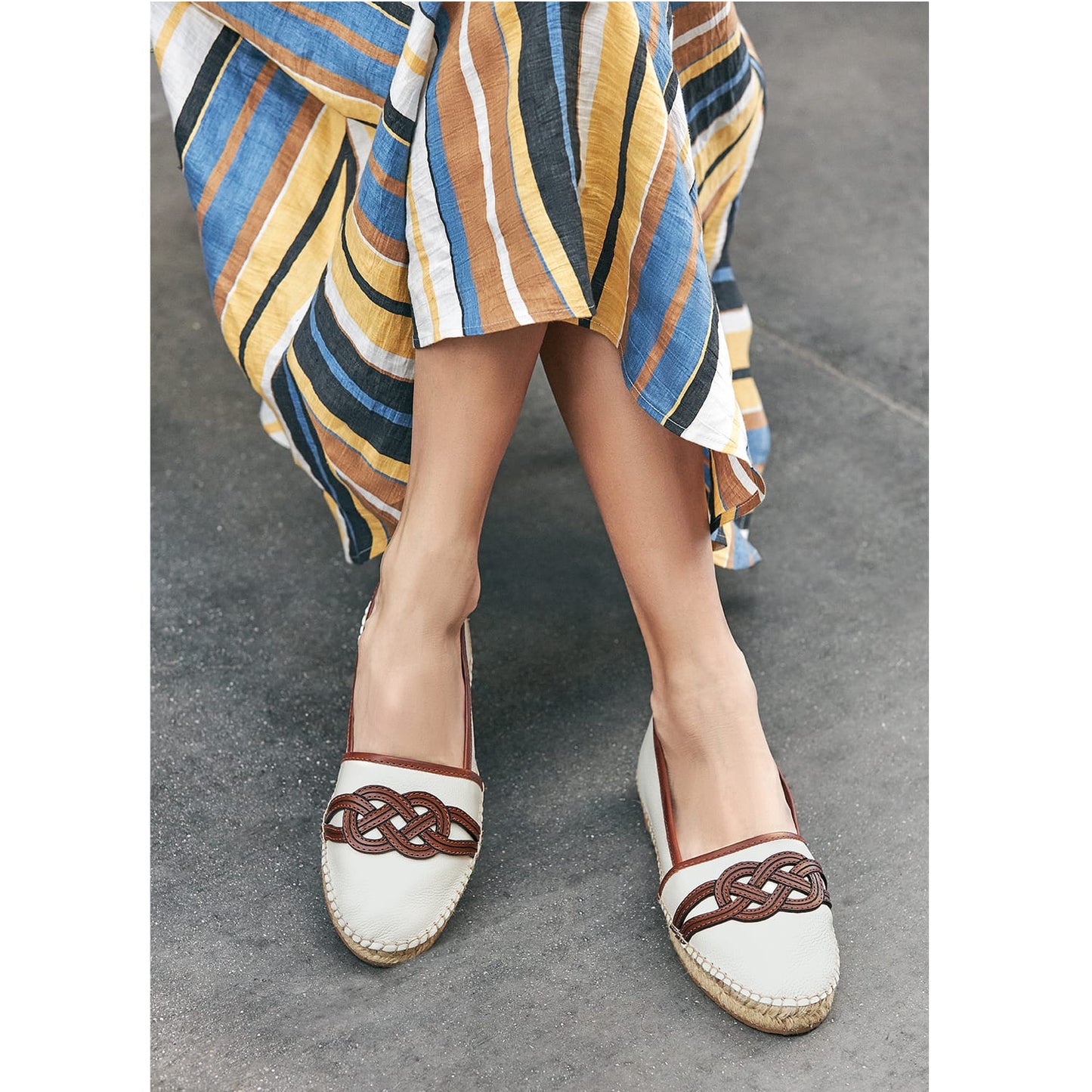 Model wearing Brighton white leather espadrille flats with woven brown leather knot detail and jute soles