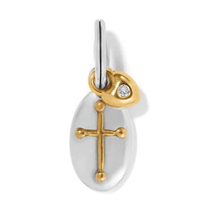 Brighton oval charm with gold cross design and small gold heart accent with crystal on a white background