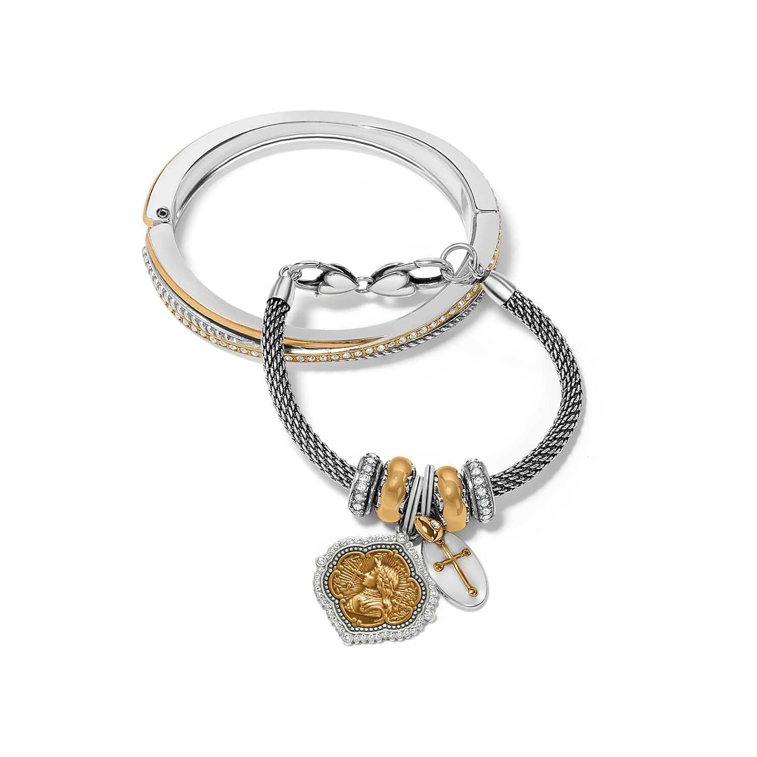 Brighton two-tone bangle and charm bracelet with crystal accents, cross charm, and medallion on a white background