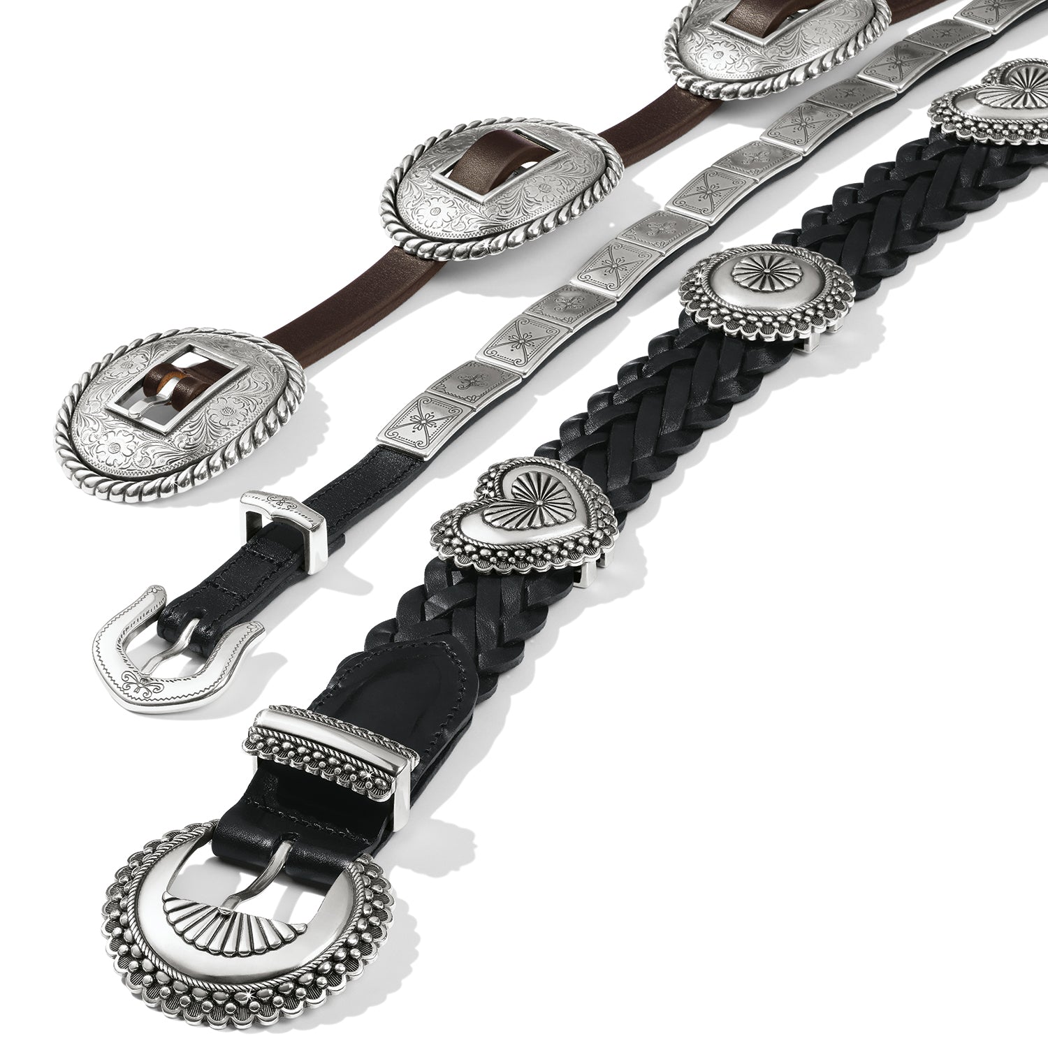 Brighton leather belts in brown and black with ornate silver-tone conchos, engraved buckles, and braided details on a white background