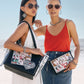 Two models, one is holding Fashionista Cover Girls Tote with sunglasses the other is holding matching pouch