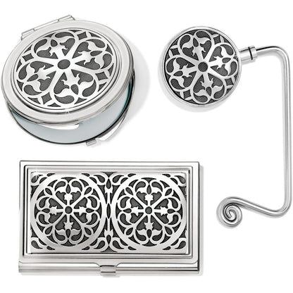 Brighton gift set with silver-tone compact, card case, and bag hook featuring ornate scrollwork medallions on a white background