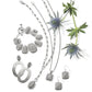 Brighton silver-plated jewelry set styled with matching bracelet, earrings, and necklaces alongside blue thistle stems