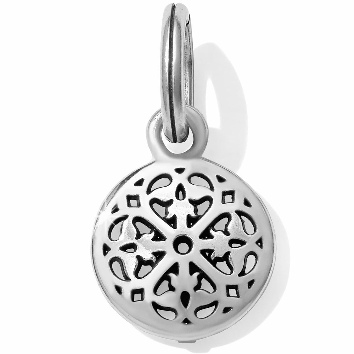Brighton charm with silver-plated round openwork medallion featuring floral cutout pattern and split ring on a white background
