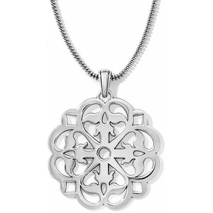 Brighton pendant necklace with silver-plated scalloped medallion featuring ornate openwork scroll design on a white background
