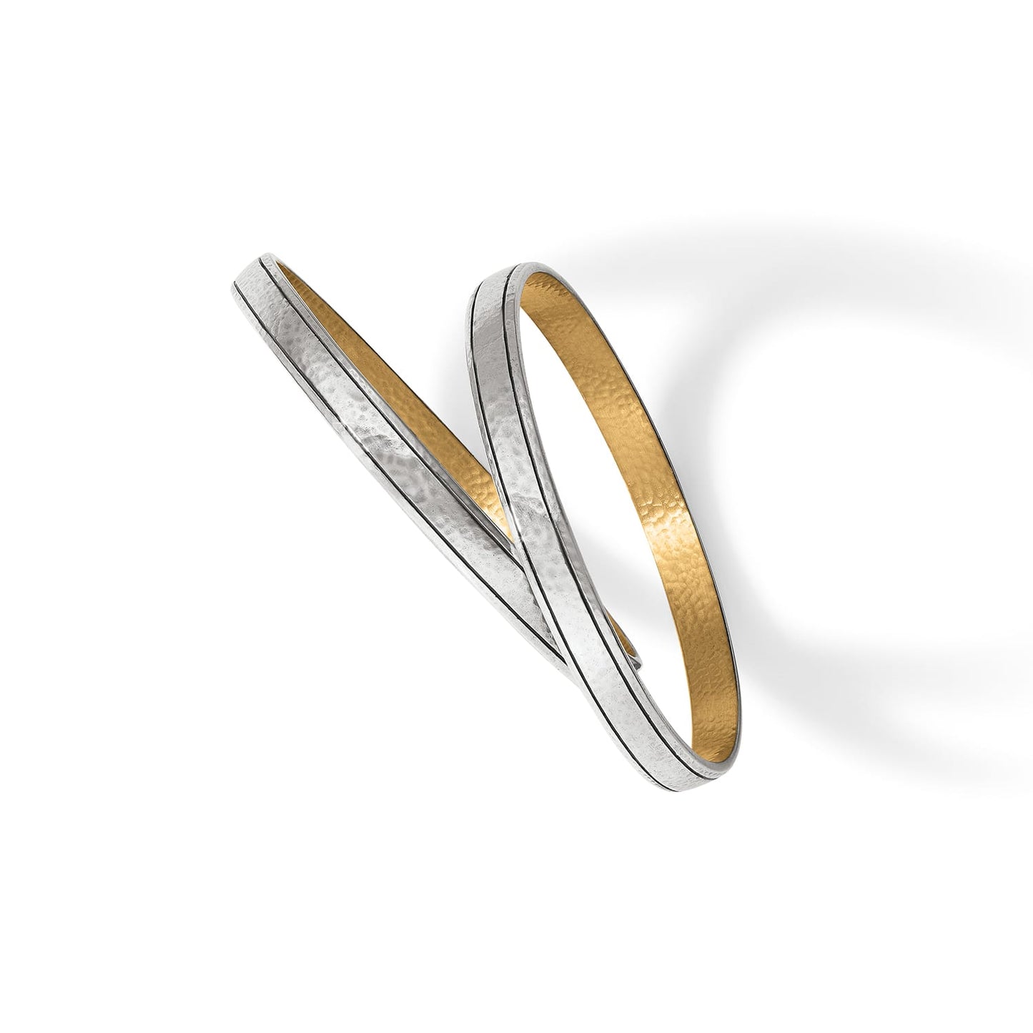 Brighton bangle bracelet with two-tone hammered silver exterior and gold interior finish on a white background
