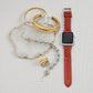 Brighton watch band in braided red leather styled with two-tone cuff bracelets and beaded bracelet on stone.
