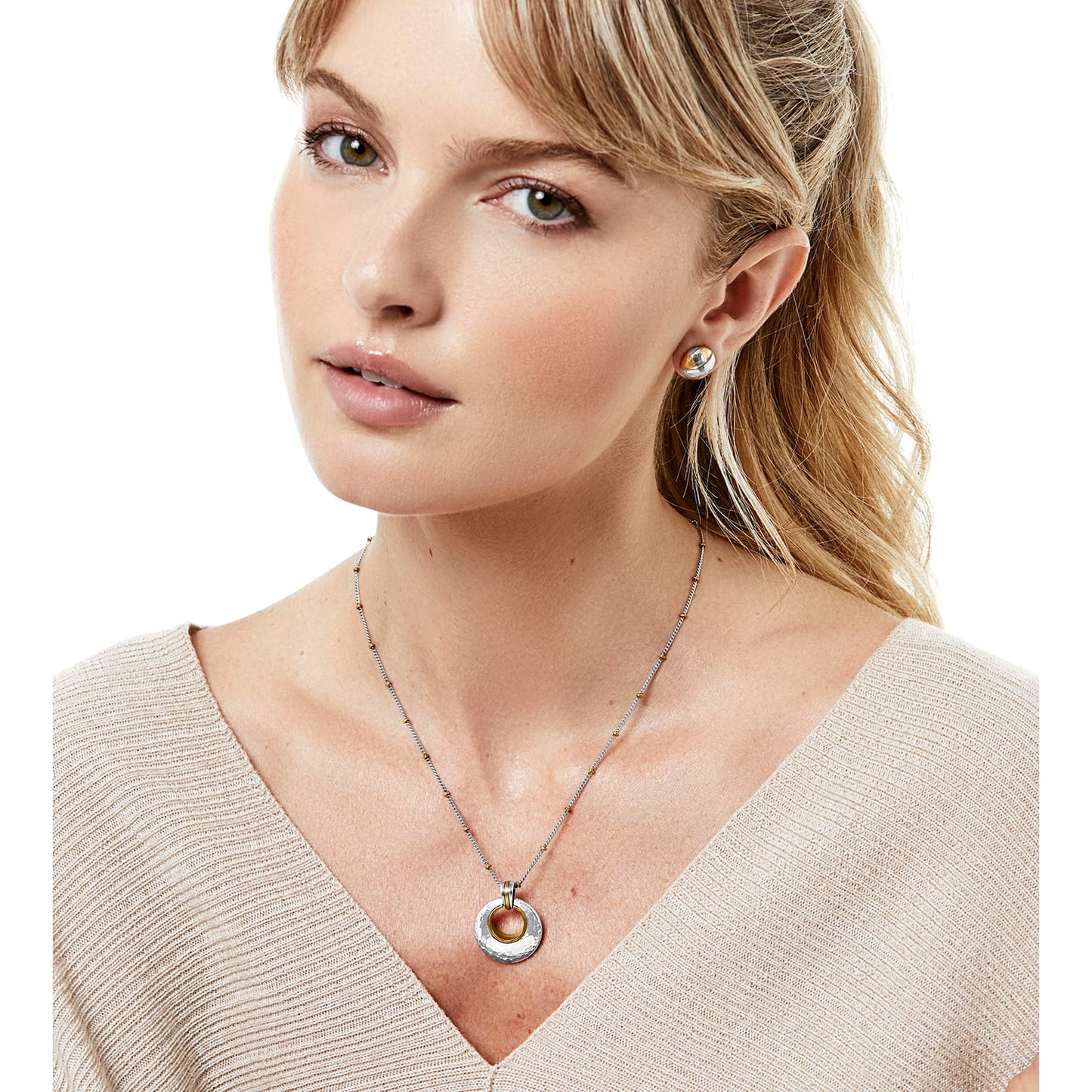 Model wearing a Brighton two-tone pendant necklace with hammered circle charm paired with matching dome stud earrings
