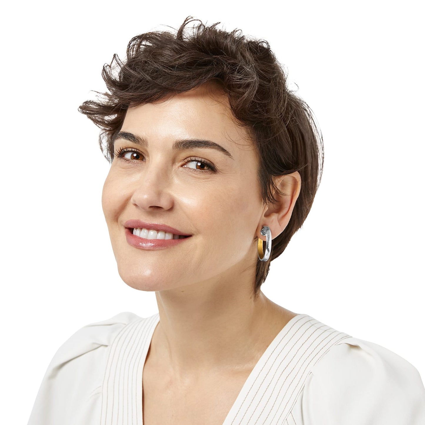 Model wearing a Brighton hoop earring with two-tone silver and gold finish and small crystal accent