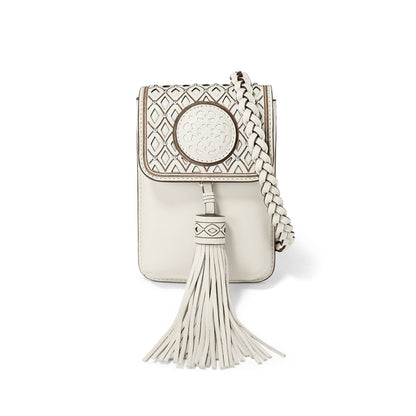 Brighton crossbody handbag in cream with diamond cutout flap, medallion accent, braided strap, and tassel on a white background