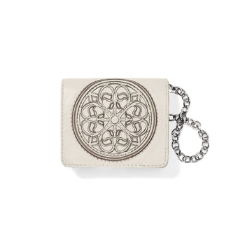 Brighton ivory leather card wallet with embossed medallion design and silver-tone chain wristlet on a white background