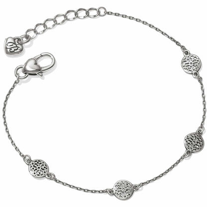 Brighton chain bracelet with three silver-plated openwork medallion stations, heart clasp, and extender chain on a white background