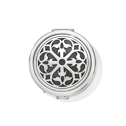 Brighton round compact with silver-tone ornate scrollwork medallion design and polished beveled edge on a white background