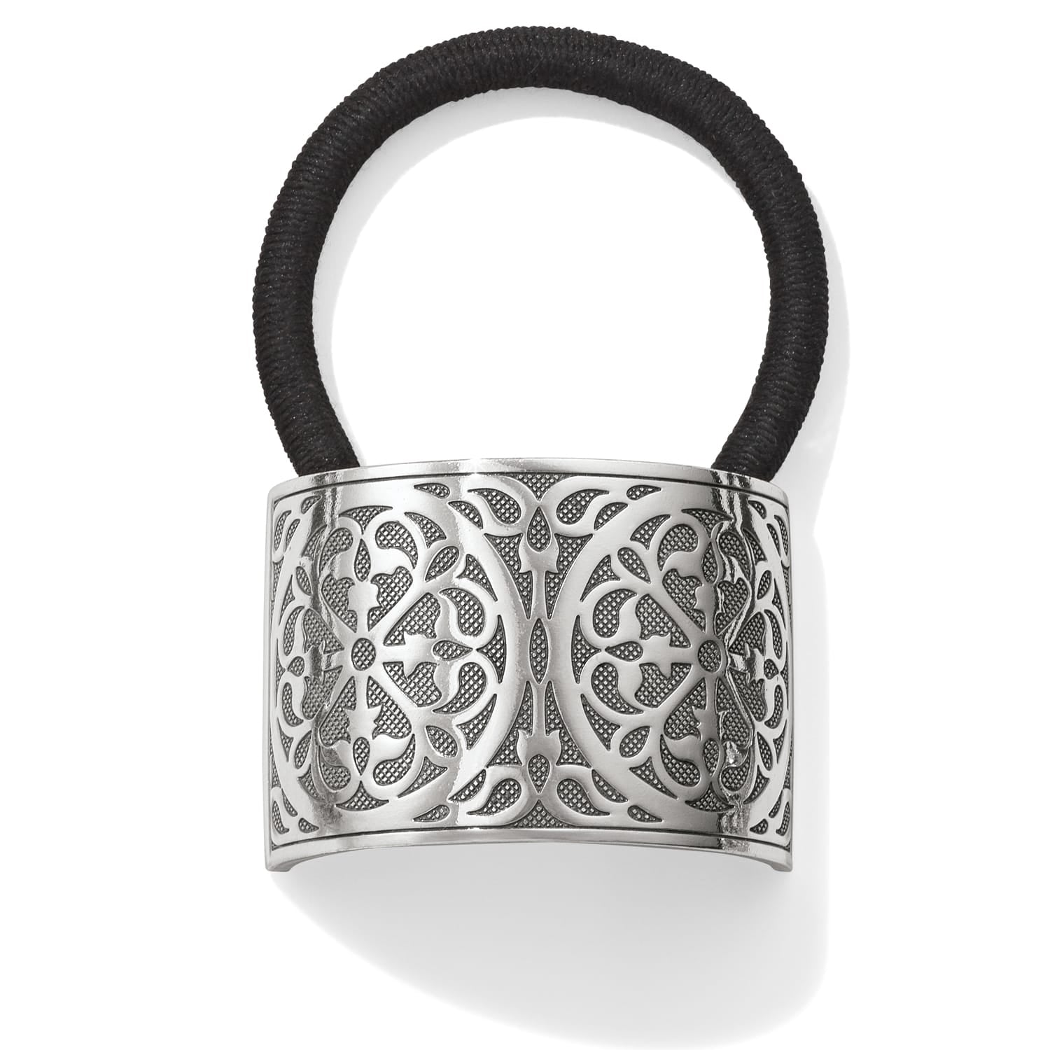 Brighton hair tie with silver-plated openwork scroll medallion and black elastic band on a white background