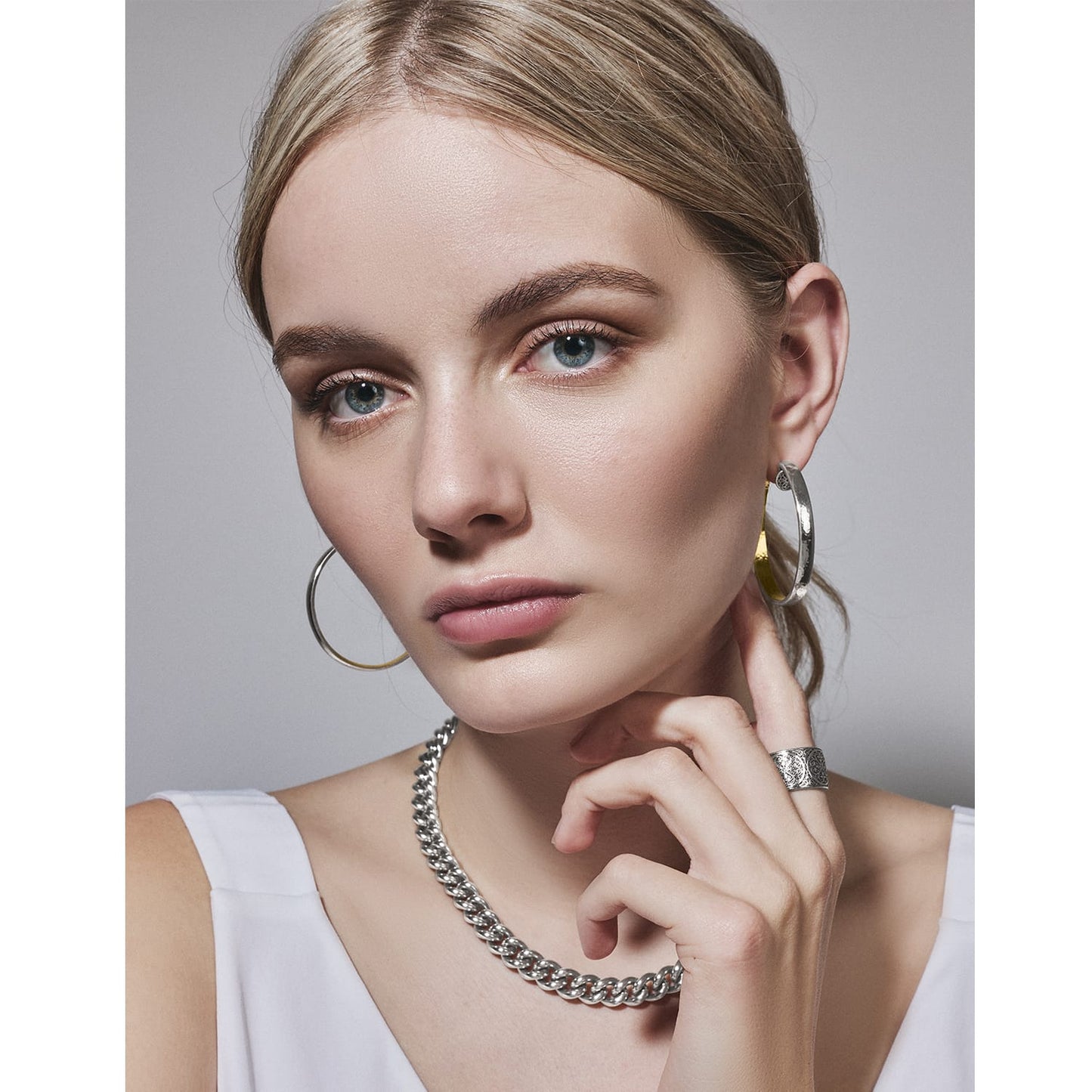 Model wearing Brighton silver-plated hoop earrings with coordinating Brighton chain necklace and engraved band ring