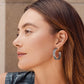 Model wearing a Brighton silver-plated hoop earring with openwork filigree detail and beaded edge trim