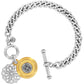 Brighton chain bracelet with two-tone medallion charms, filigree detail, and toggle clasp on a white background