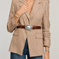 Model wearing a Brighton brown leather belt with oval silver-tone engraved buckle over a houndstooth blazer