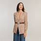 Model wearing a Brighton brown croc-embossed leather belt with ornate silver-tone oval buckle over houndstooth blazer