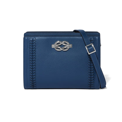 Brighton blue leather crossbody handbag with silver-tone knot accent, braided side details, and adjustable strap on a white background