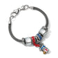 Brighton charm bracelet with clear, red, and blue crystal beads and enamel charm on a white background