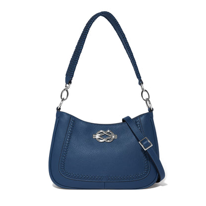 Brighton shoulder handbag in blue pebbled leather with silver-tone knot emblem and braided handle on a white background