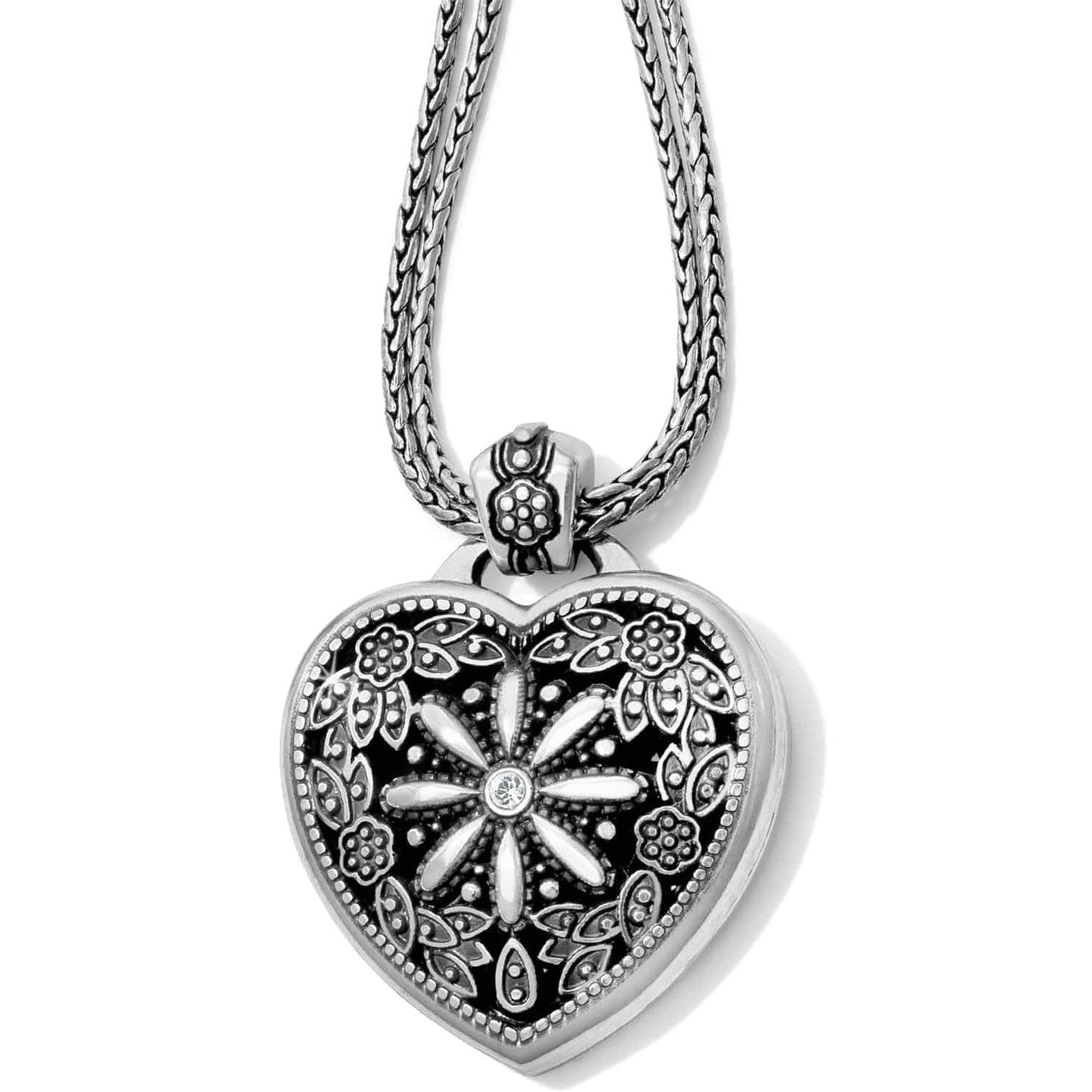 Brighton heart pendant necklace with silver-plated floral filigree design, crystal center, and braided chain on a white background