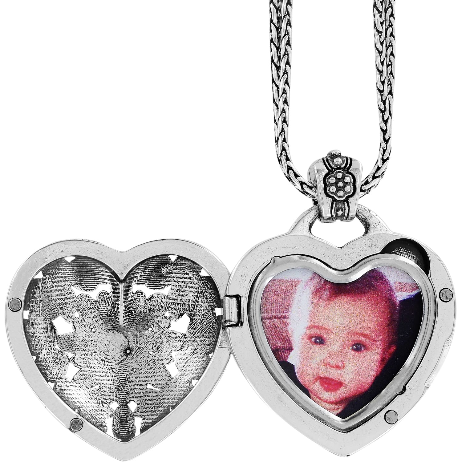 Brighton silver-plated heart locket necklace shown open with baby photo inside and braided chain on a white background